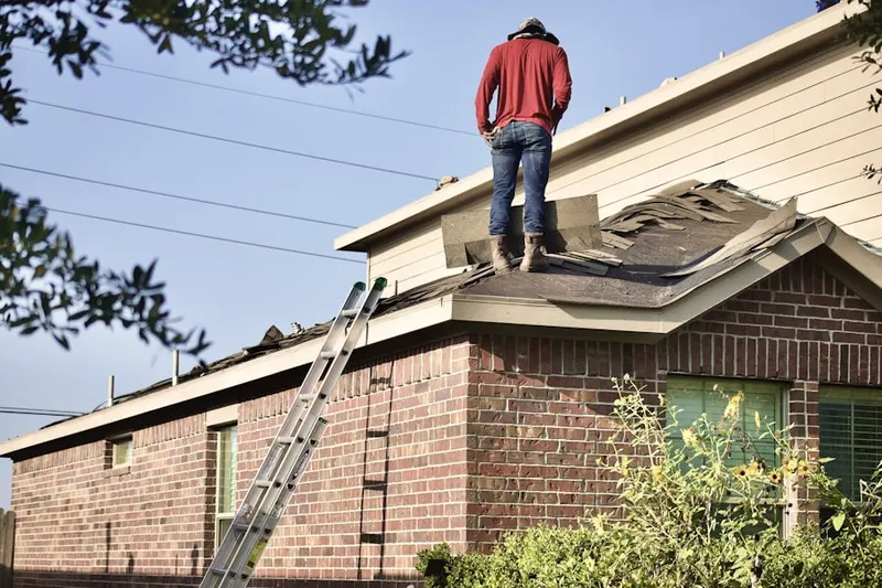 Professional roofer working on a residential roof in Ednor Farms